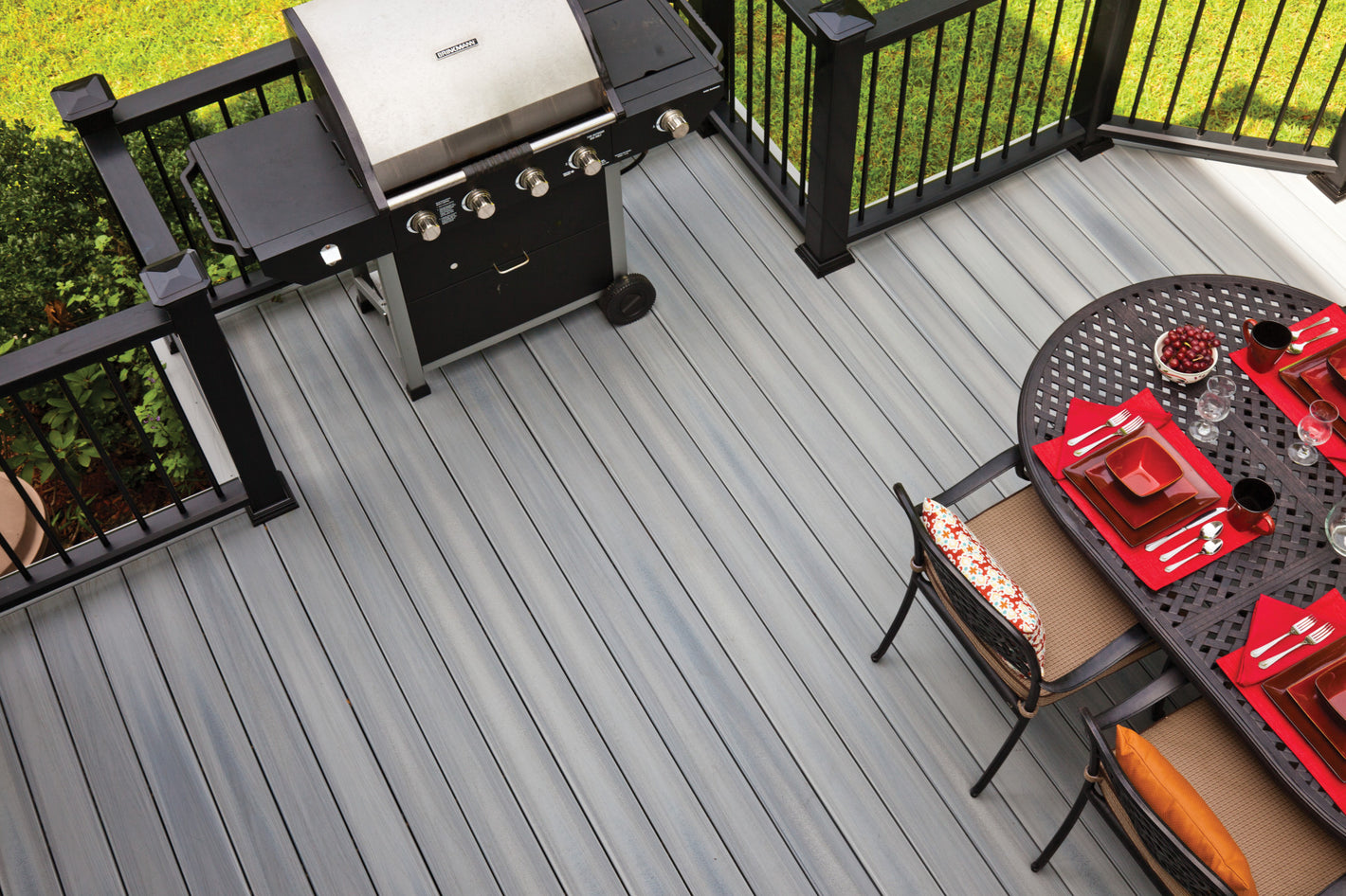 Fiberon Concordia Castle Gray composite deck with black railing, barbecue, and dining table