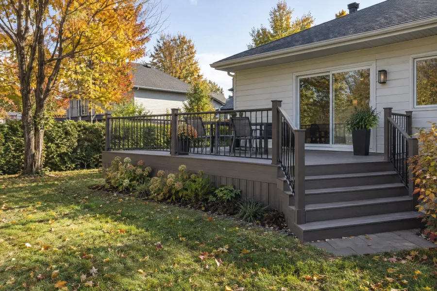 Composite deck with railings and stairs in a suburban South Shore backyard in autumn